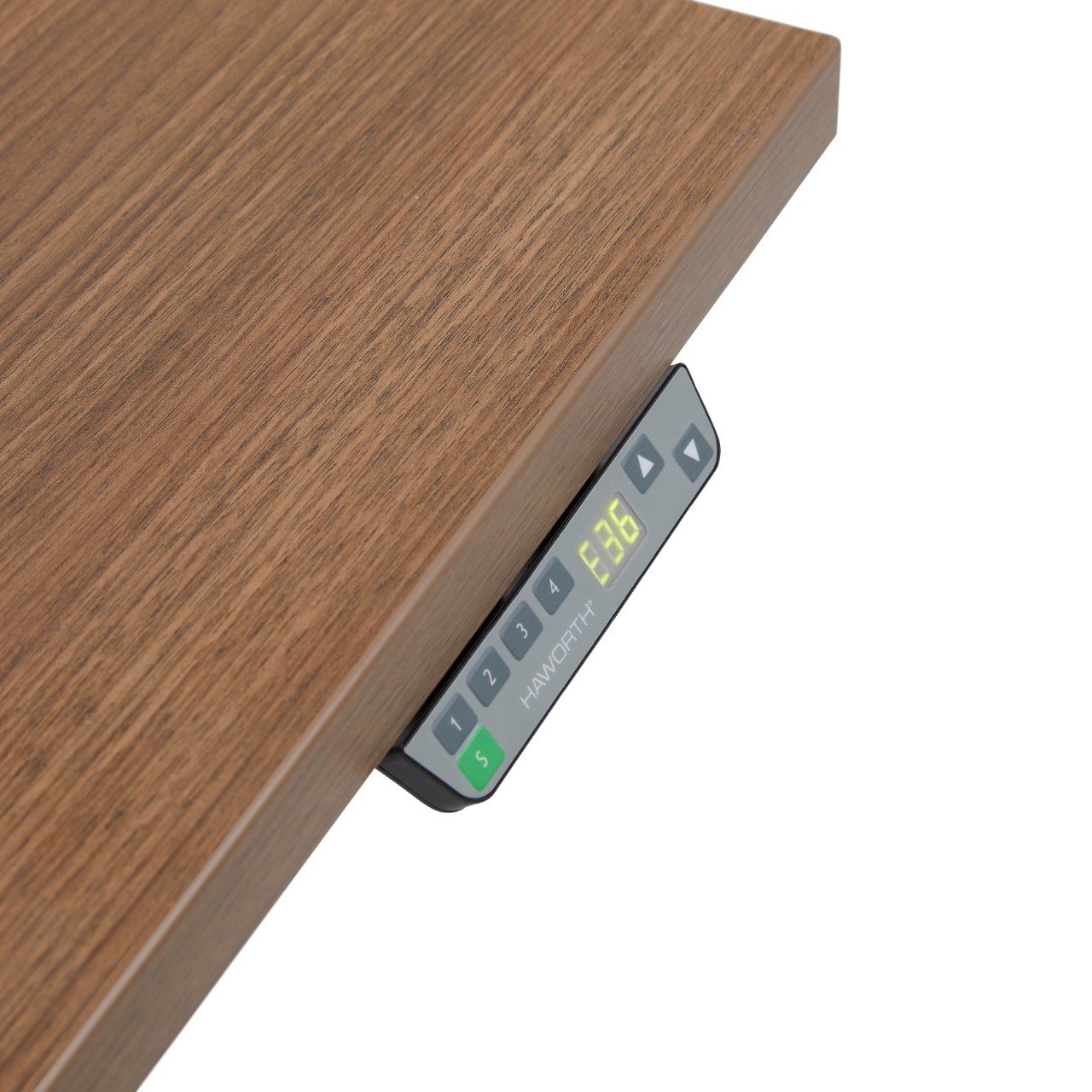 A digital weighing scale showing 63.6 pounds or kilograms underneath a wooden surface.