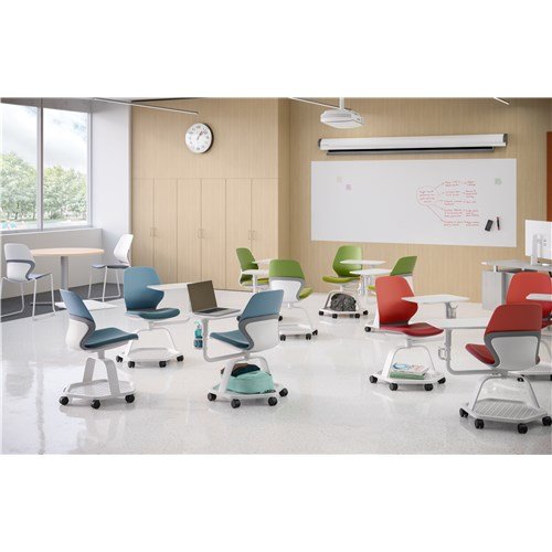 Classroom with colorful chairs, white rolling desks, a whiteboard, a clock on the wall, and large windows letting in natural light.