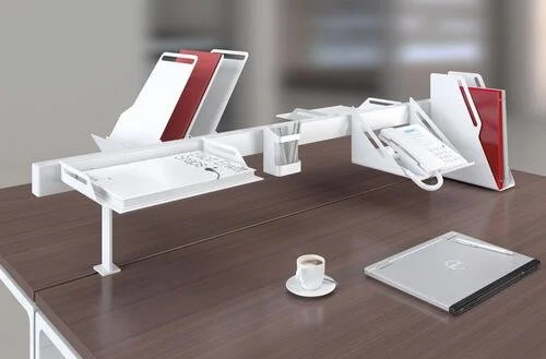 Desk organization with files, a telephone, a printer, and a closed laptop.
