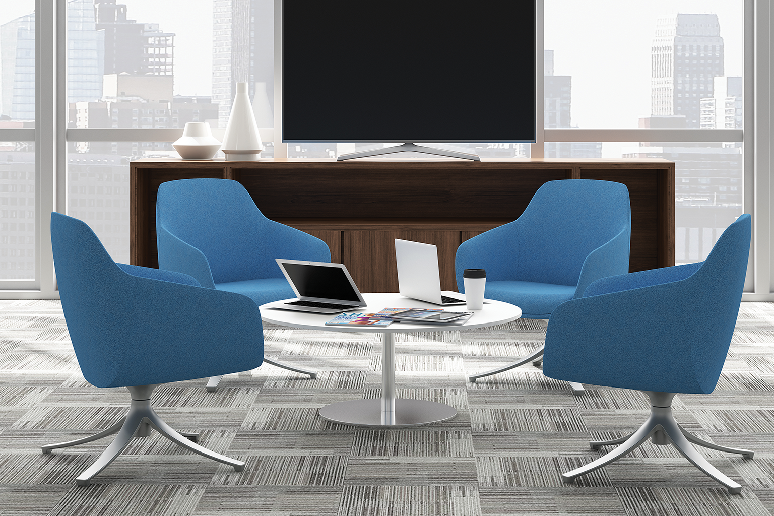 Modern conference room with four blue chairs around a white round table, laptops, a tablet, a coffee cup, and magazines, with city skyline view through large windows and a wooden console holding vases and a flat-screen TV.