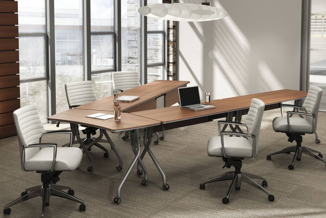 Modern conference room with a wooden table, six white office chairs, a laptop, notebooks, and large windows with city view.