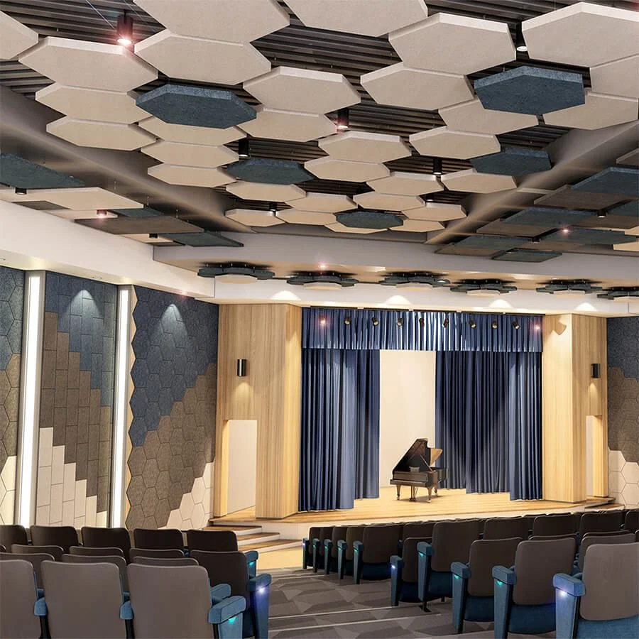 A modern auditorium with a grand piano on stage, surrounded by dark blue curtains, and rows of chairs facing the stage, with acoustic panels on the ceiling and walls.