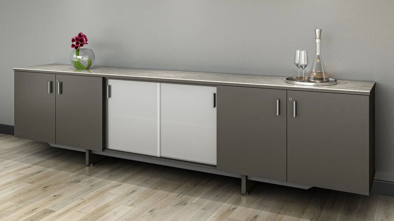 Modern sideboard with two sliding glass doors, a gray and white cabinet, decorated with a vase of purple flowers and glassware on a gray wall background.