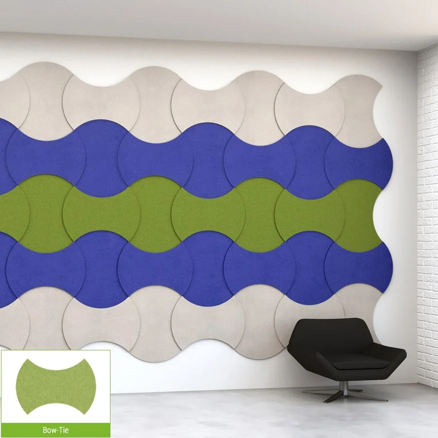 Decorative wall with interlocking oval-shaped panels in beige, blue, and green, along with a black lounge chair in a modern room.