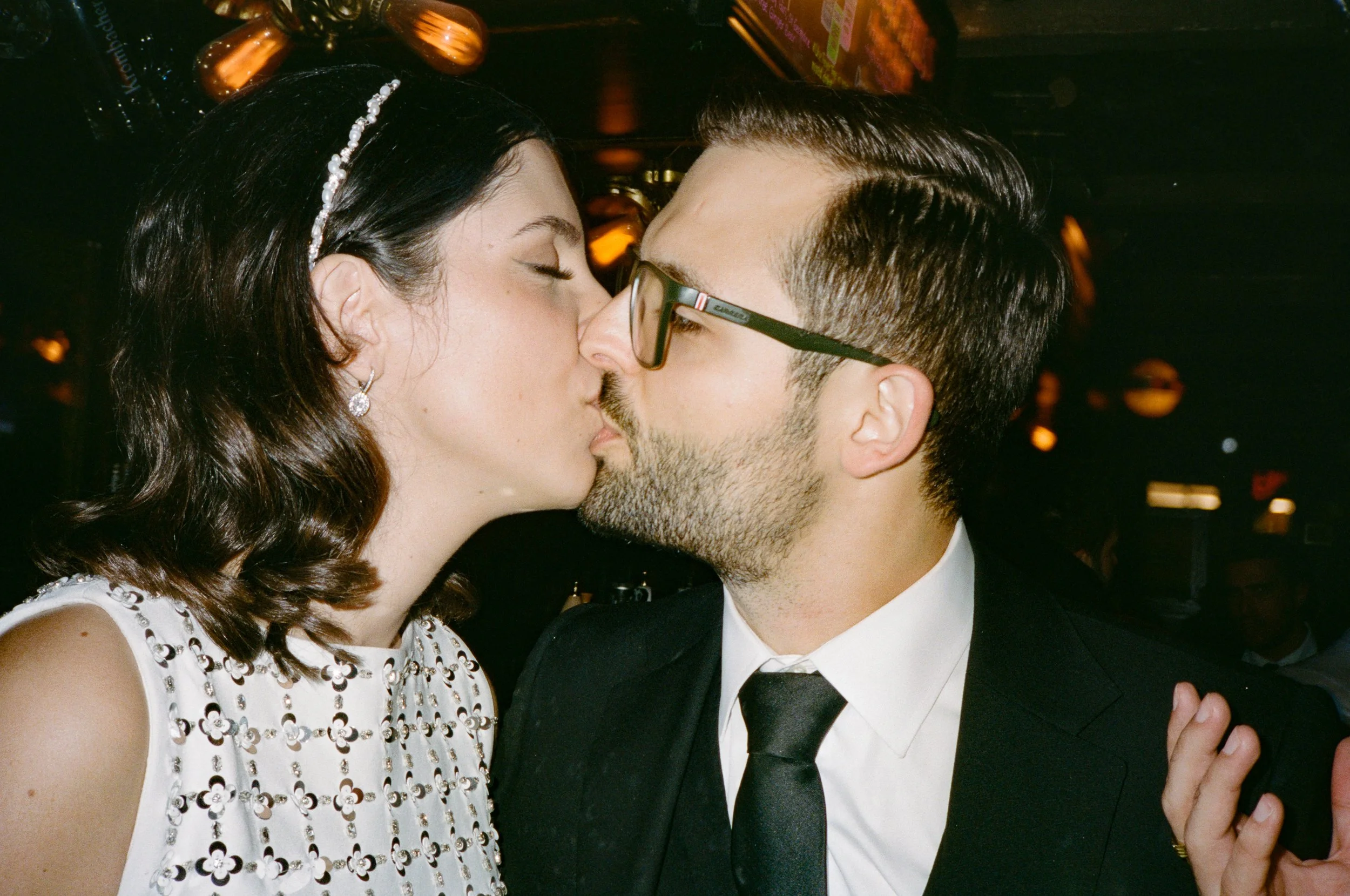 A woman and a man are sharing a kiss.