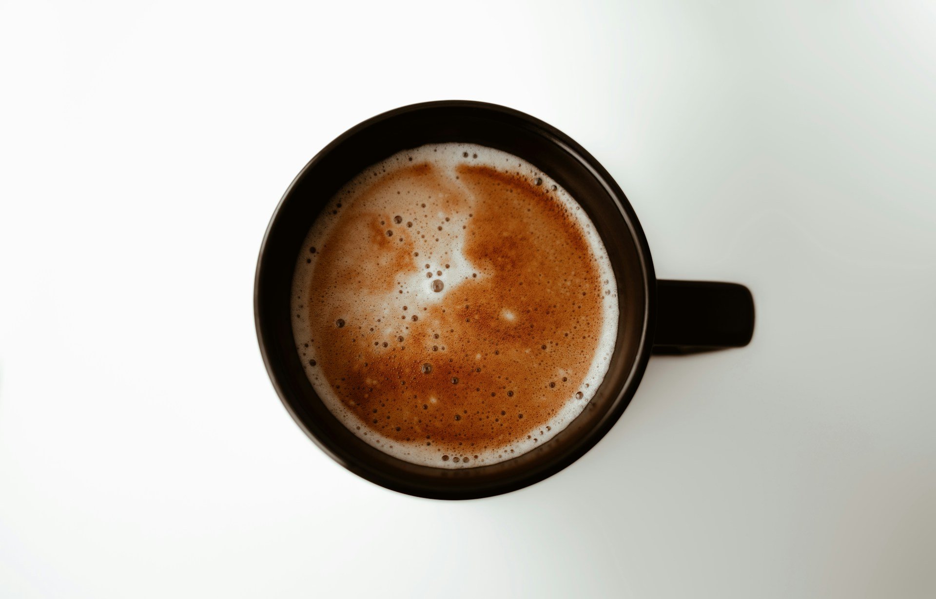 Cup of coffee from above, highlighting caffeine, natural energy, workout performance and pre-workout nutrition.