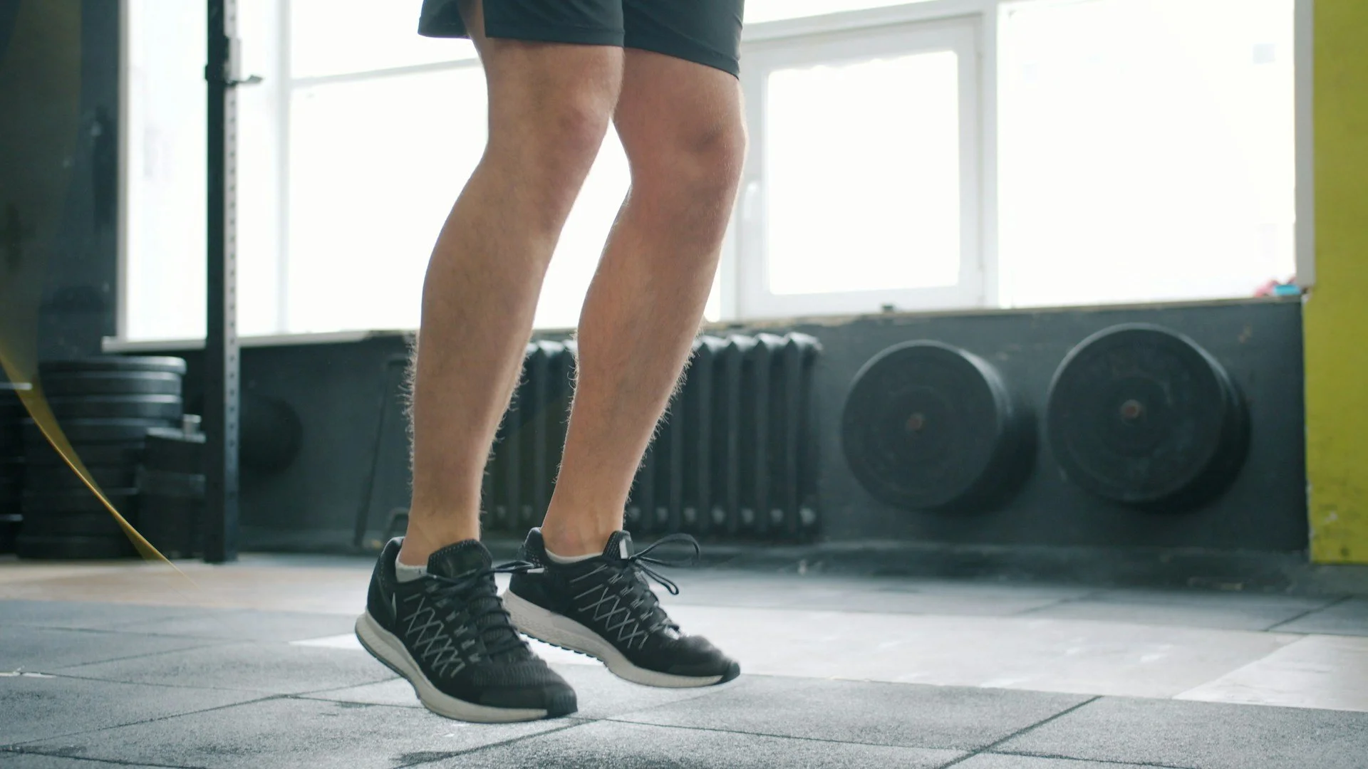 Person jumping rope in a gym as part of a cardio workout.