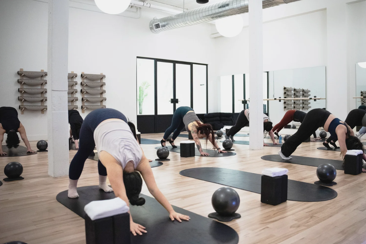 Group Pilates class at VIMALIFE, highlighting mobility, strength, core training and mindful movement in Leslieville.