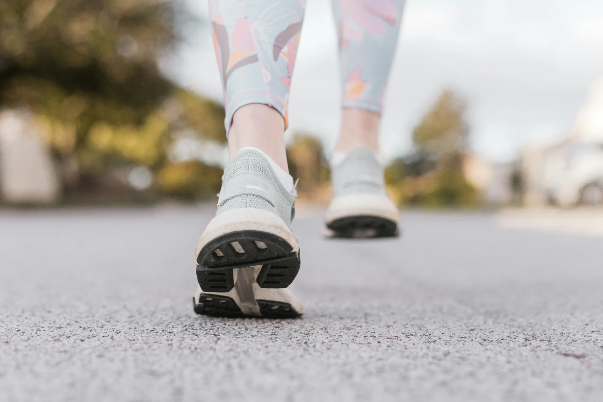 Close-up of walking shoes on pavement during an outdoor walk