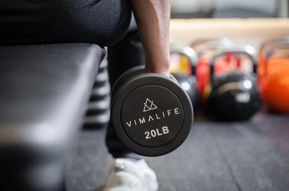 VIMALIFE dumbbell strength training workout with free weights at a boutique fitness club in Leslieville, Toronto.