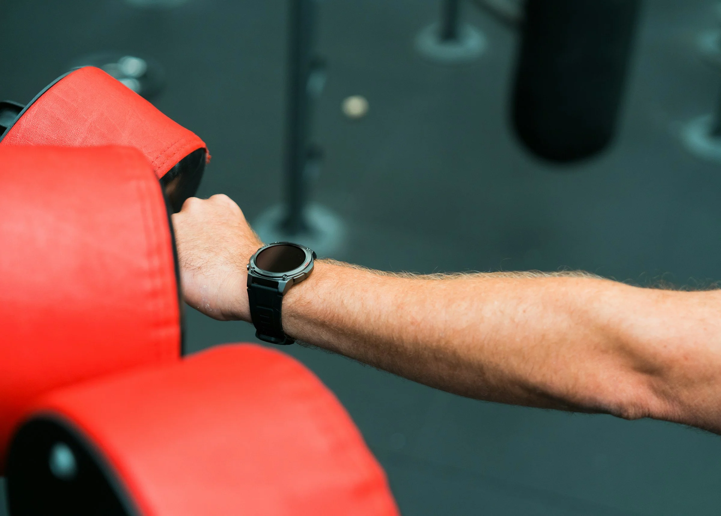 Person wearing a fitness tracker while boxing, highlighting workout intensity, heart rate tracking and cardio training.