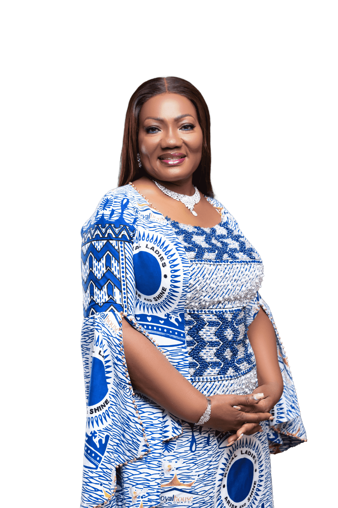 Our Premier Lady in a blue and white patterned dress, wearing jewelry, smiling with arms crossed in front of a plain background.
