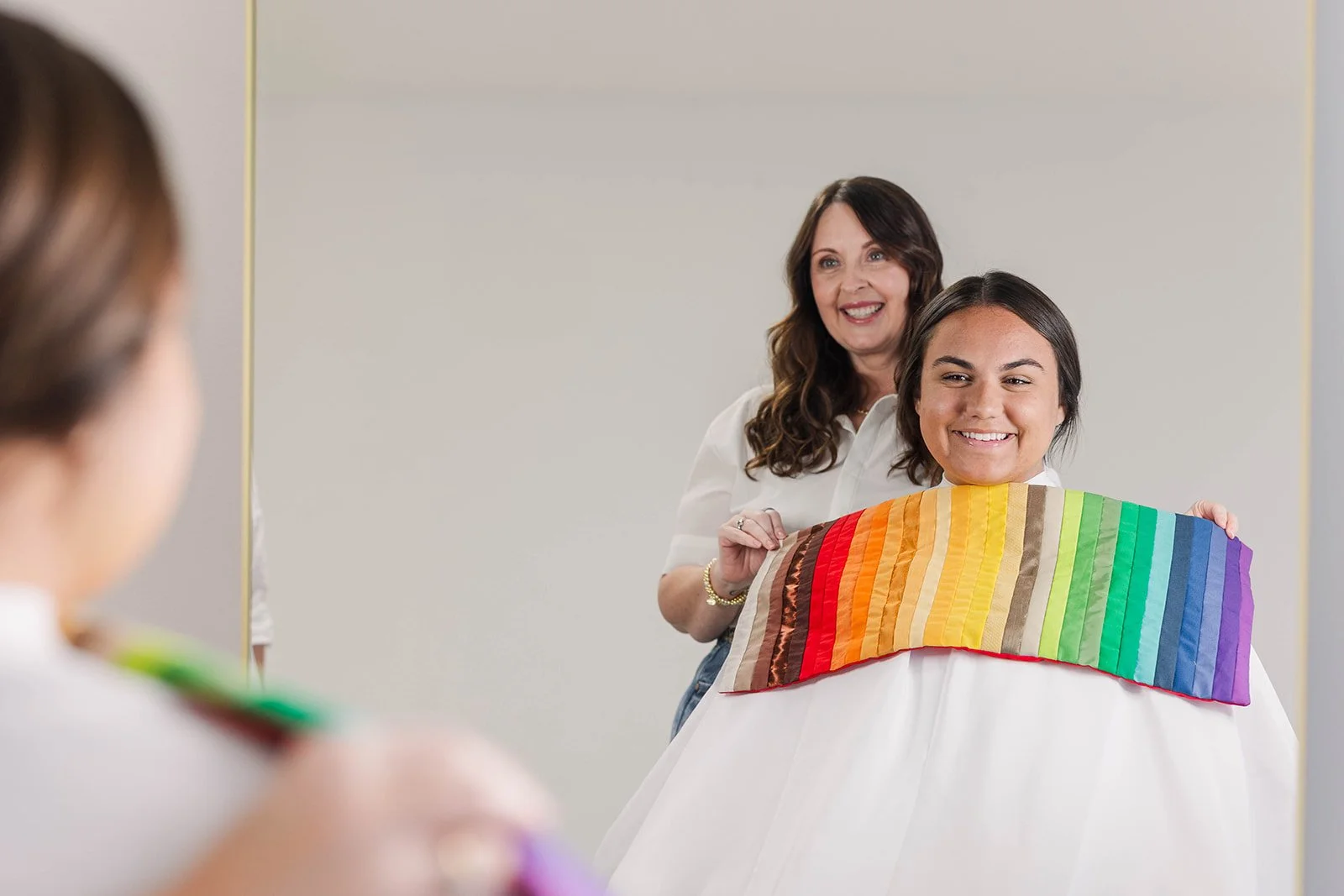 A woman gets draped with a color analysis flag