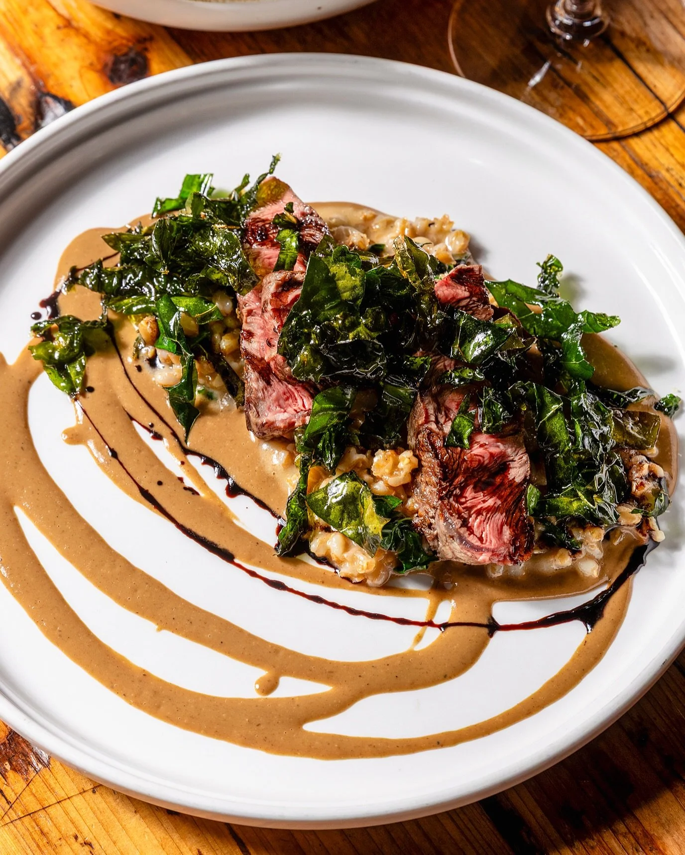 Michigan Beef Tagliata with balsamic, porcini, lacinato kale, and farro just landed on the tasting menu and we can&rsquo;t stop thinking about it. Chef Eddie and the crew went full Italian American on this whole lineup and we need to talk about it. P