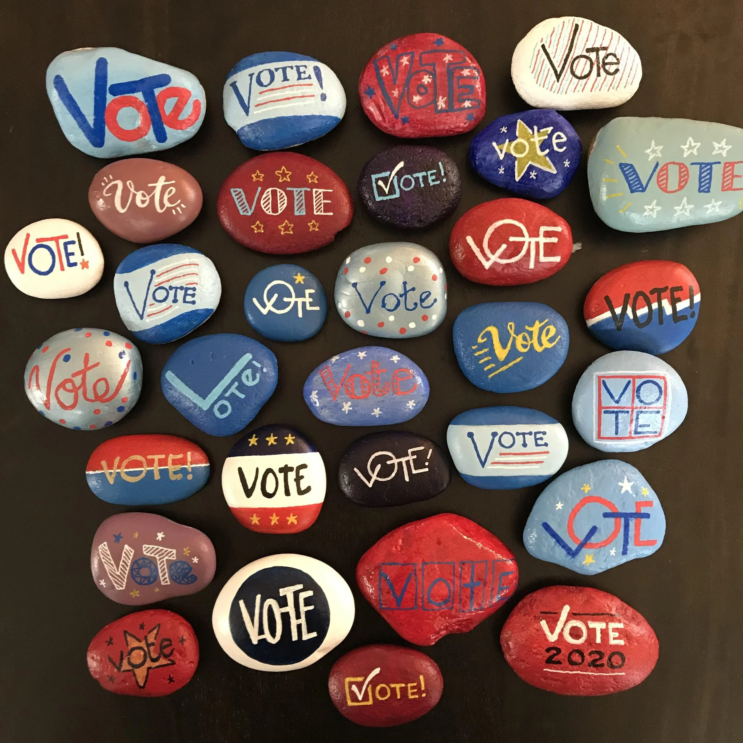 Rocks painted with "vote" messaging.