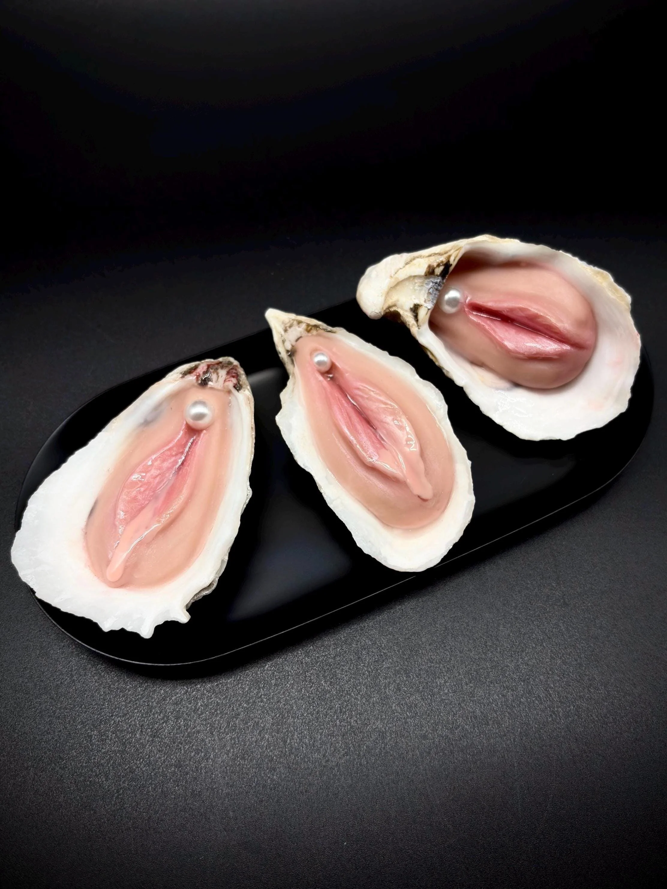 Moister handmade oyster shell oddity sculpture on black background