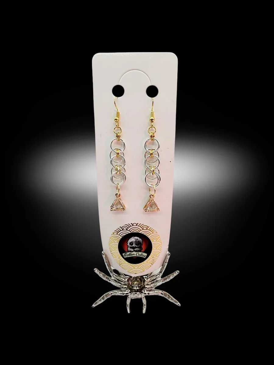 mixed metal chainmail earrings with gold and silver rings and geometric triangle charm on display card