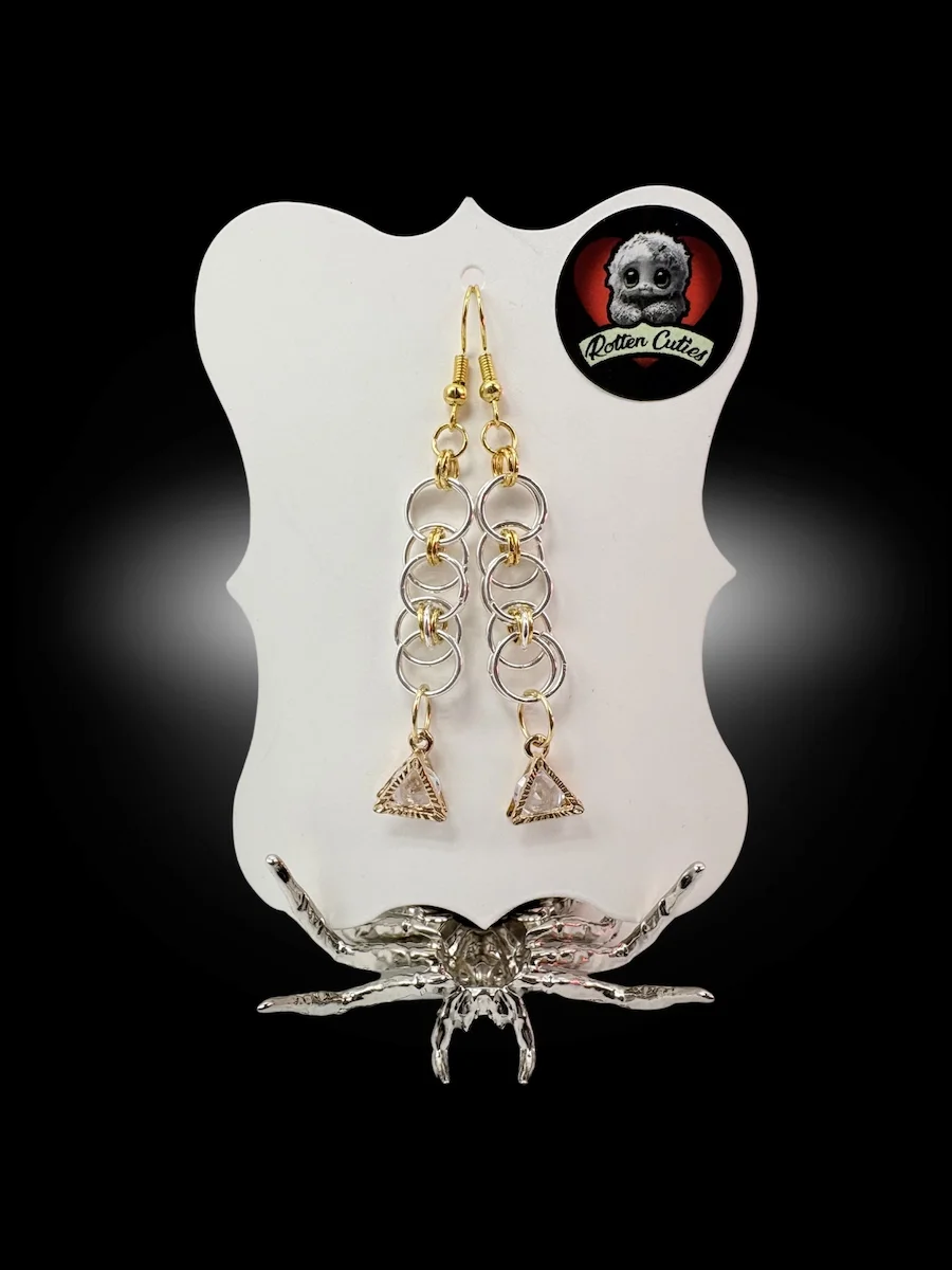 mixed metal chainmail earrings with gold and silver rings and geometric triangle charm on display card