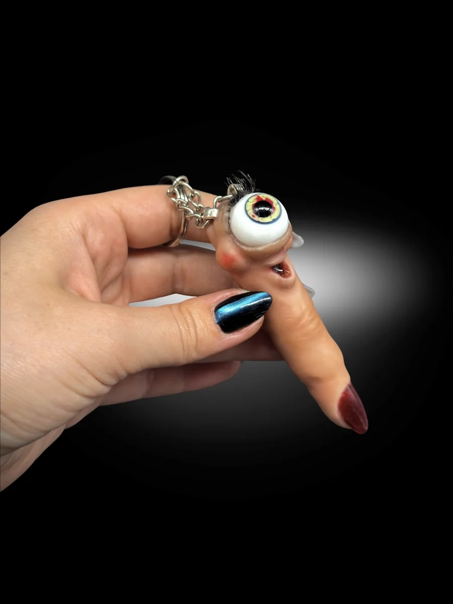 Handmade surreal finger sculpture with eye close-up showing texture and detail