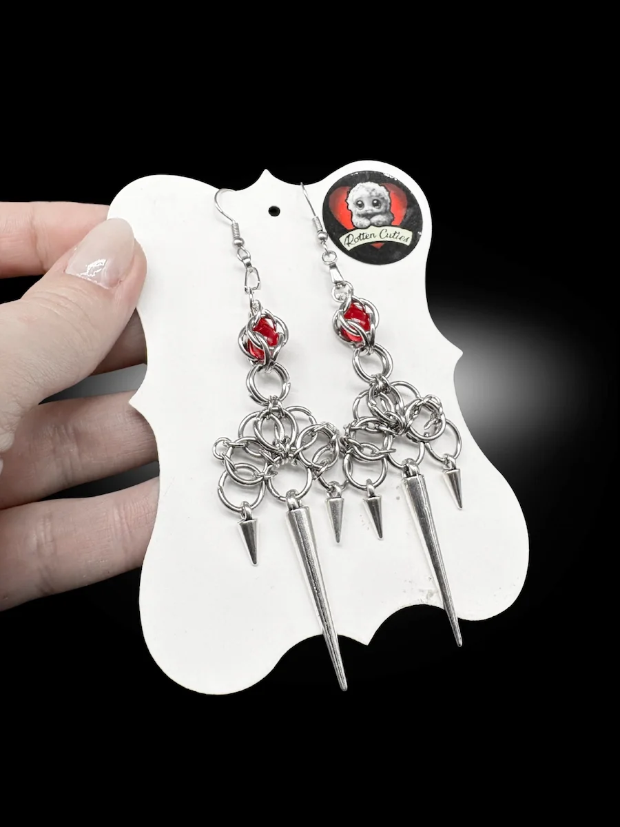 Warlord spiked chainmail earrings held in hand gothic statement jewelry with red accents