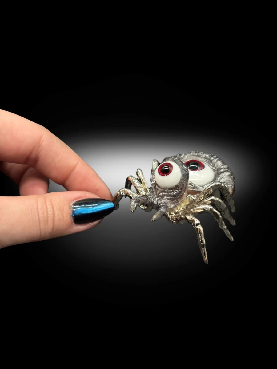 surreal creepy cute spider art piece with metallic finish and multiple eyes