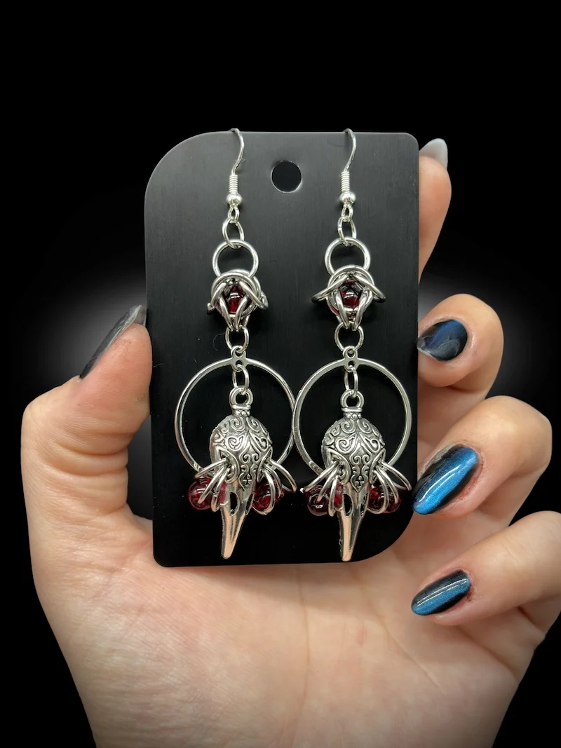 Birds Are Not Real handmade gothic earrings angled view showing metal texture and design