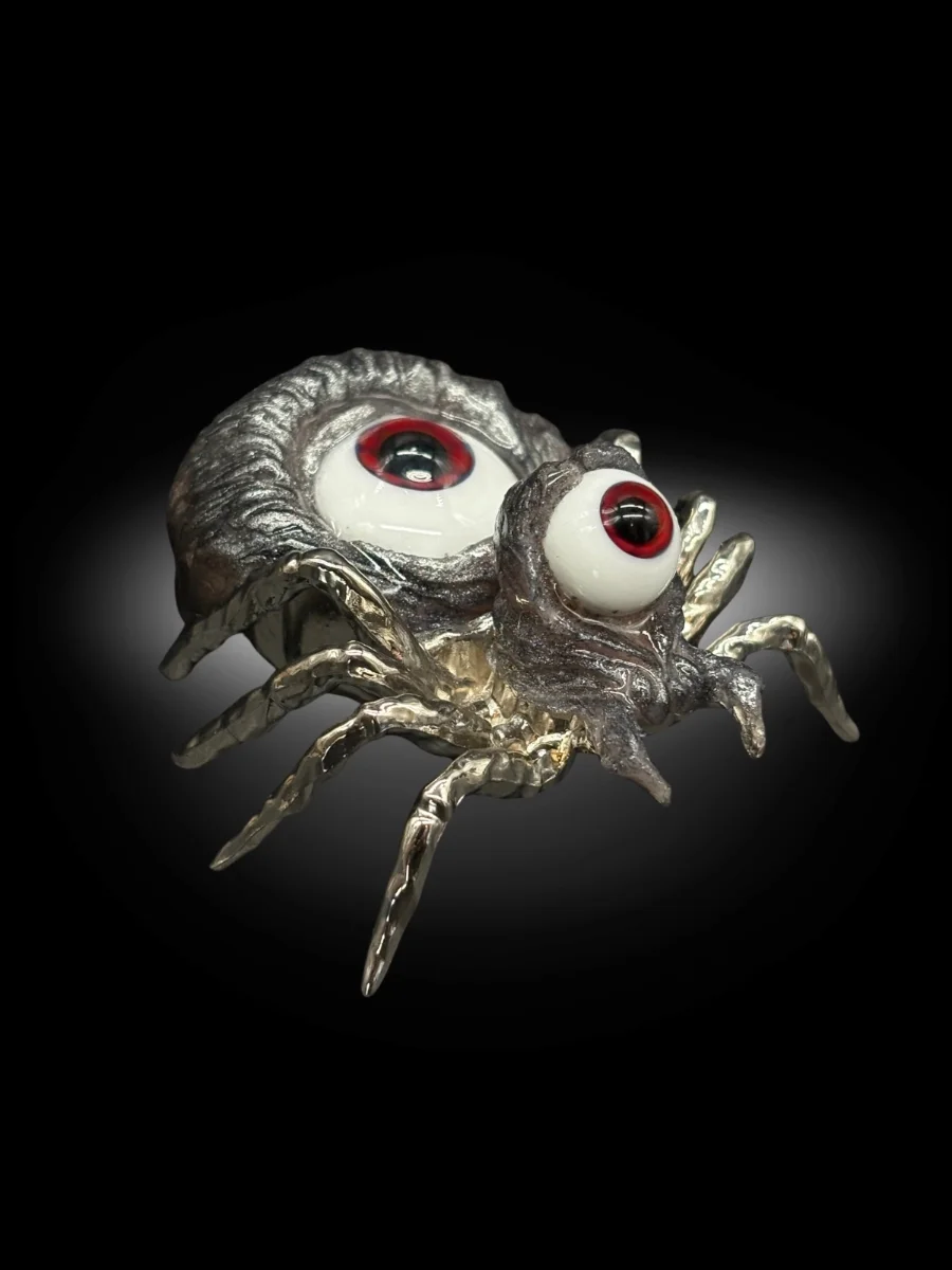 close up of creepy spider sculpture with realistic eyeballs and textured body