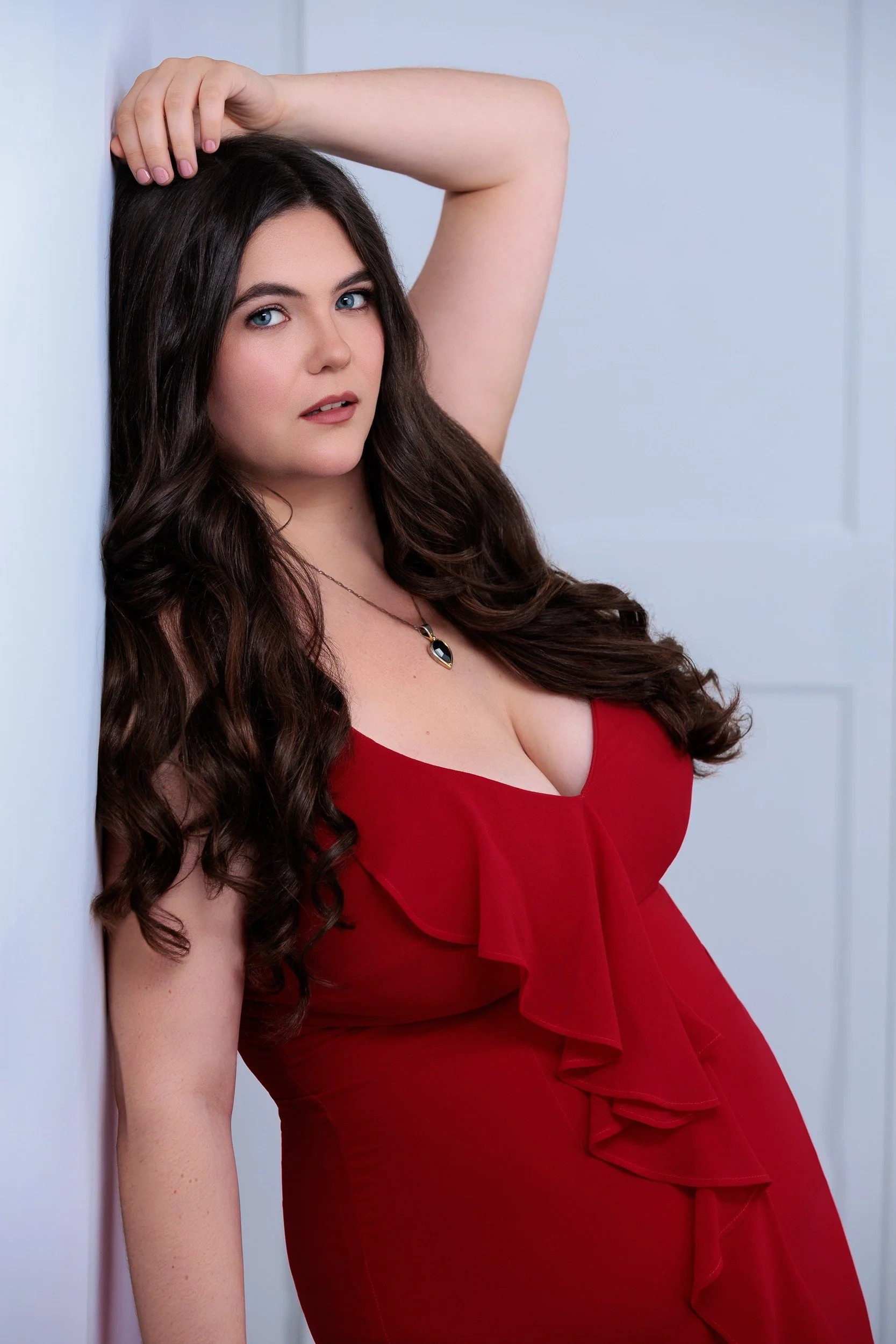 Glamour portrait of a young woman wearing a red dress at the studio in Duncan