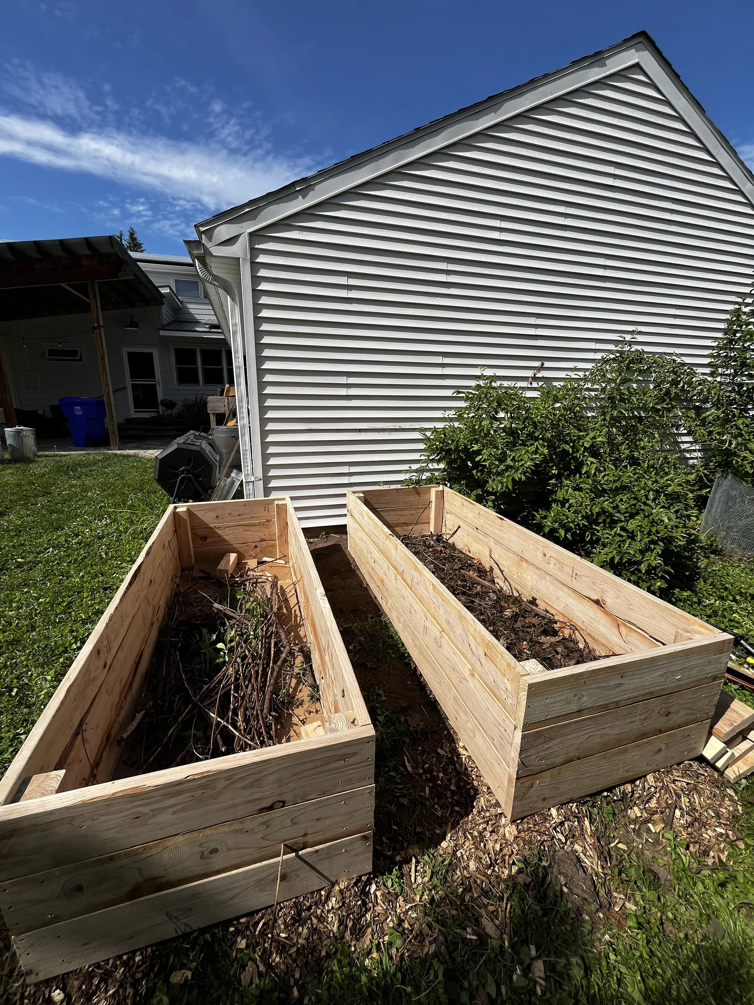 Filling beds with organic materials - logs, sticks, and leaves. 