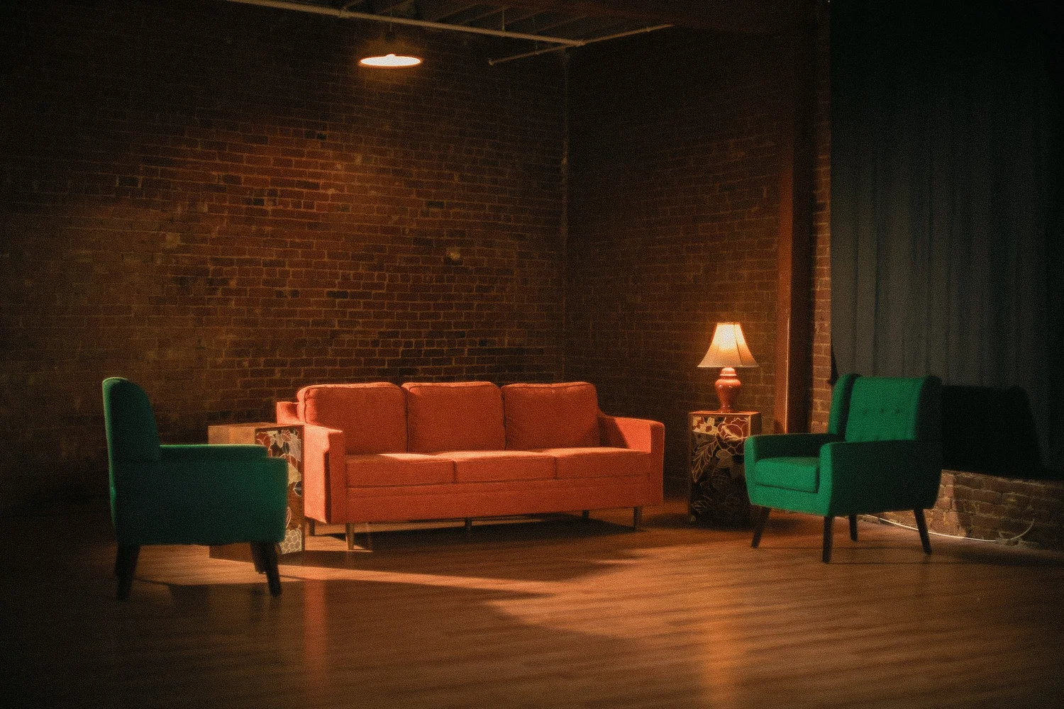 Studio lounge with curtains drawn and warm lamp light