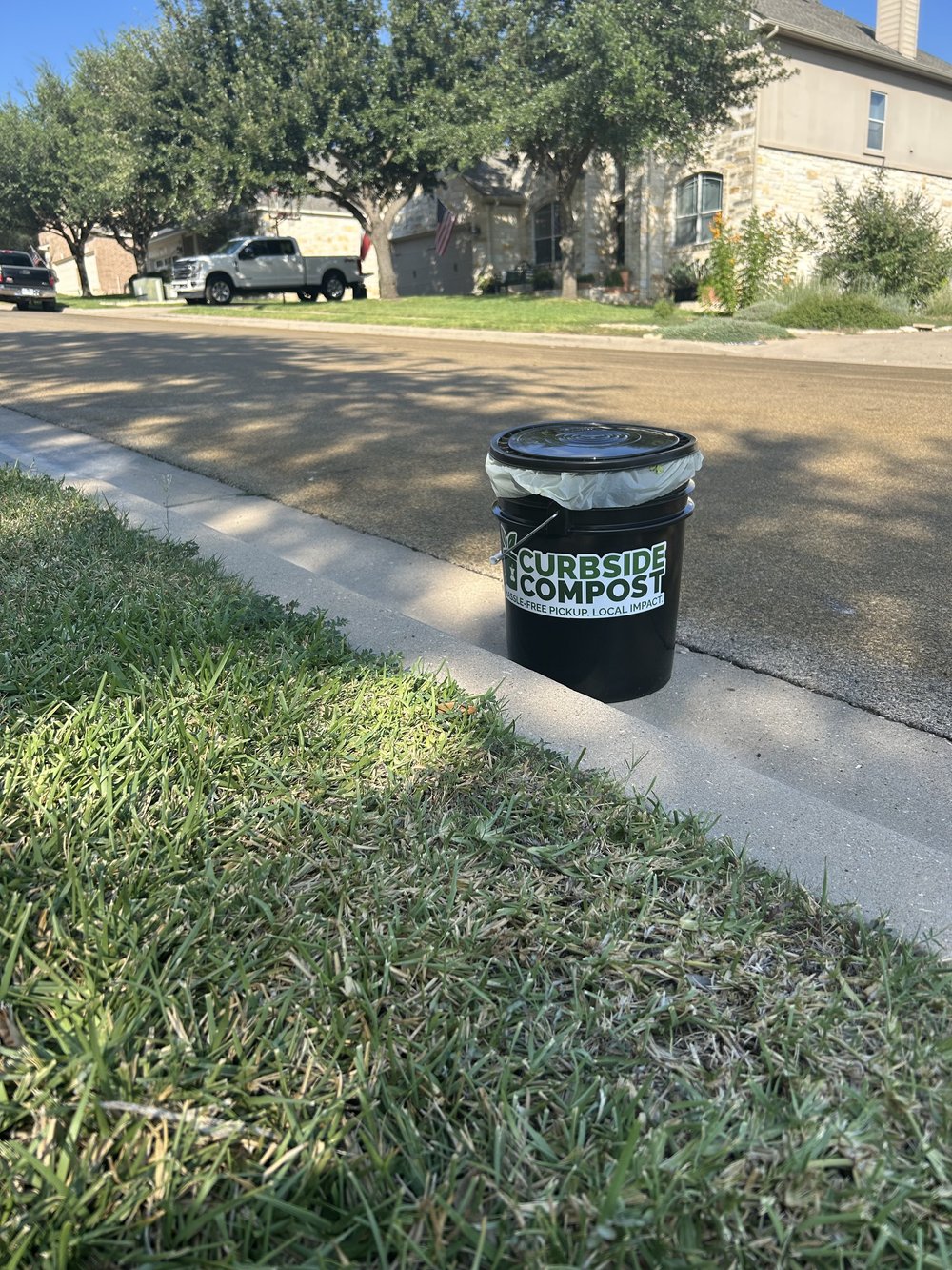 Curbside Compost bin on the curb in a Cedar Park neighborhood