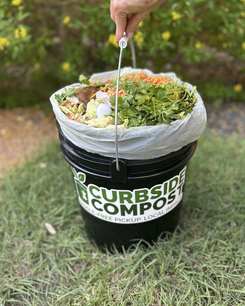 Food scraps being added to a Curbside Compost bin