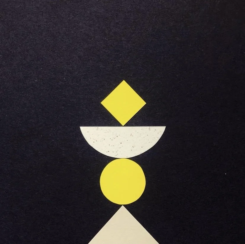 Abstract geometric design with yellow and white shapes on a black background