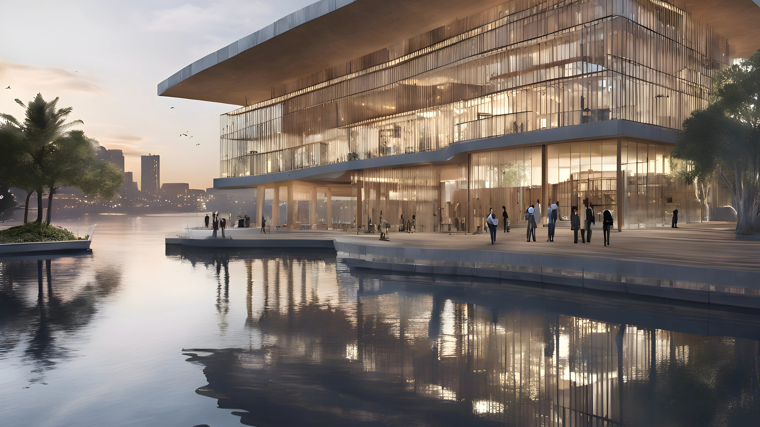 Modern glass building by water at sunset with people walking on pathway and trees around.