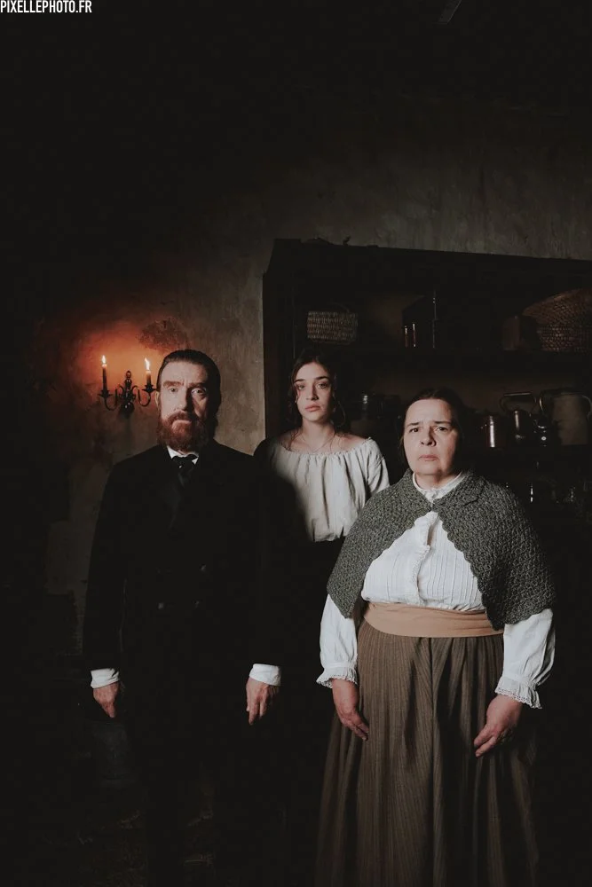 A man, woman, and girl in 19th c. clothes