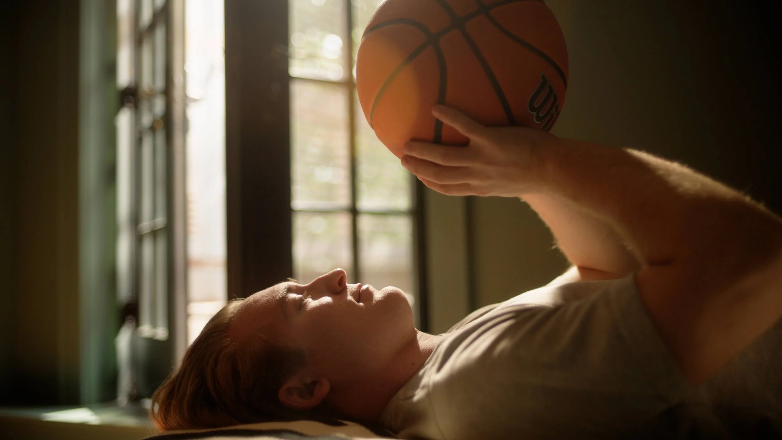 Young college student holding basketball