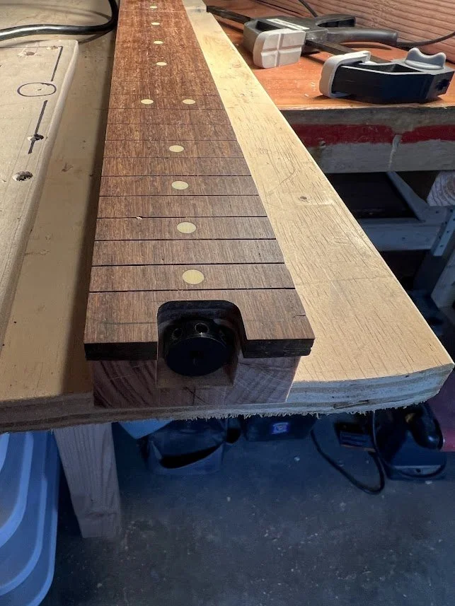 Close-up view of a guitar fretboard waiting for frets.