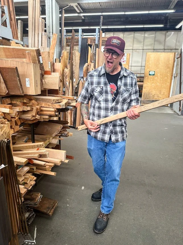 Michael playing 'air guitar' with a piece of maple