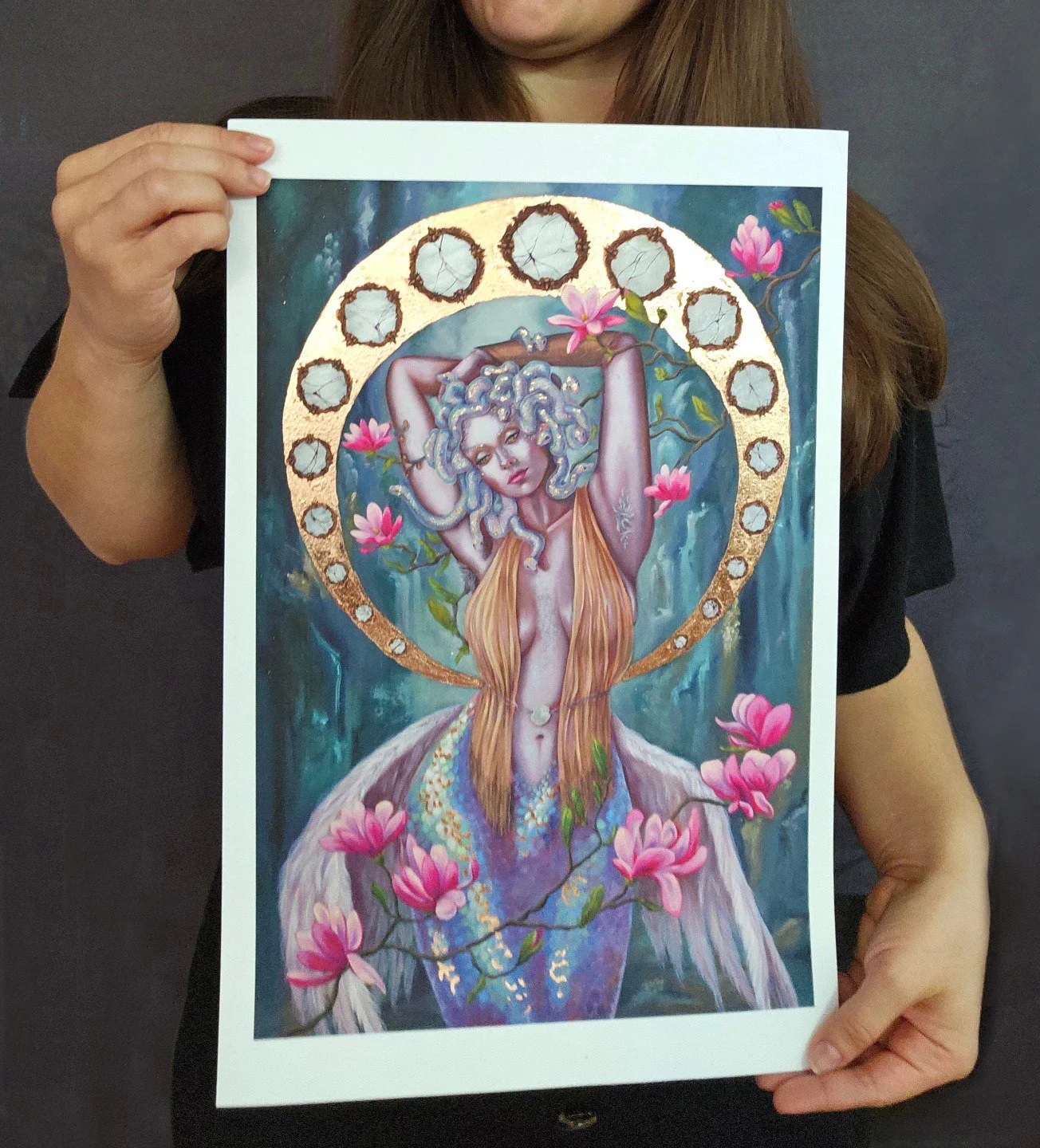 An artist showcasing her hand embellished fine art print