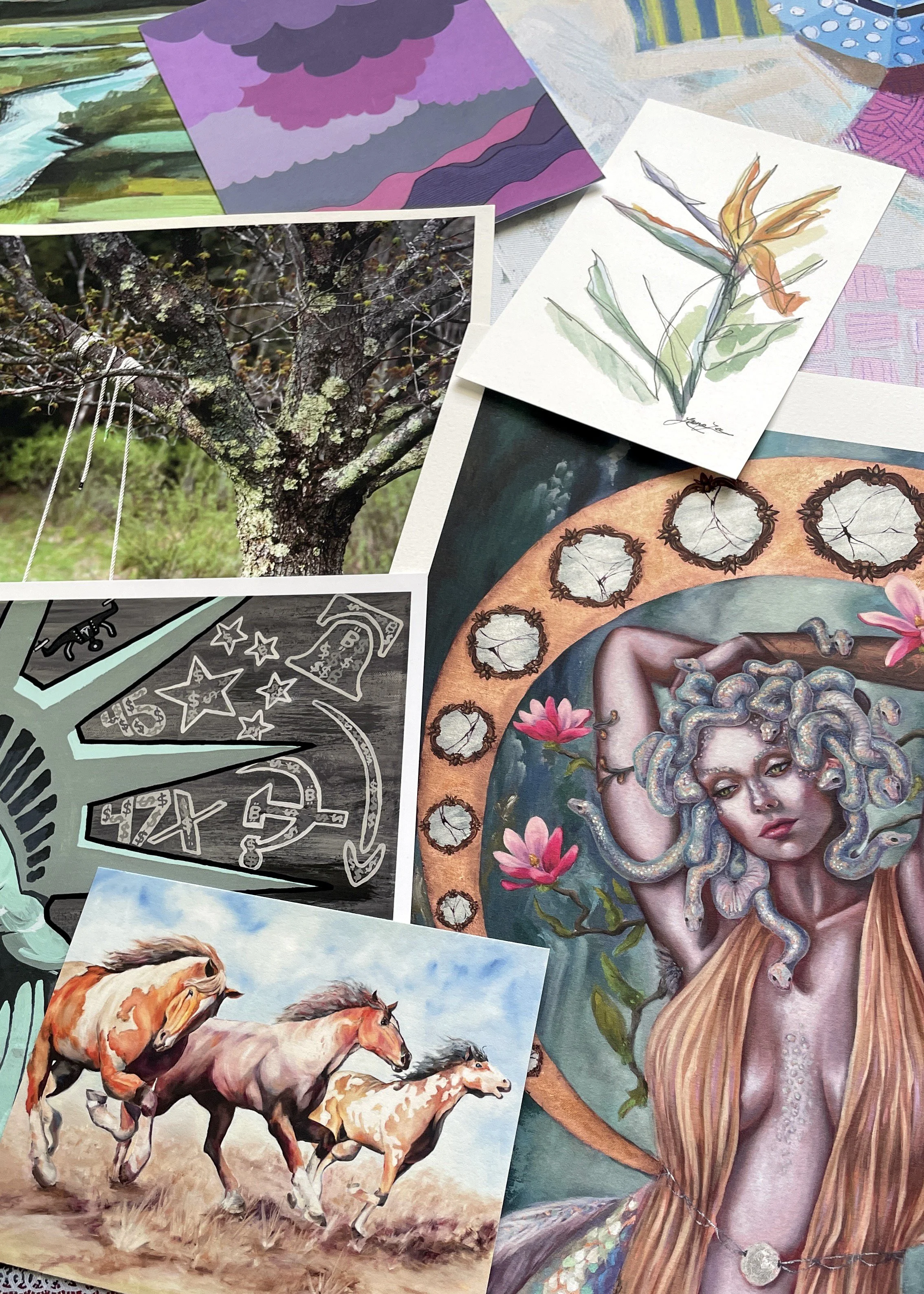 A collection of various fine art prints, including a photograph of a tree with lichen, a botanical watercolor painting, a realistic painting of horses running, and a painted portrait of a medusa surrounded by flowers and moon phases.