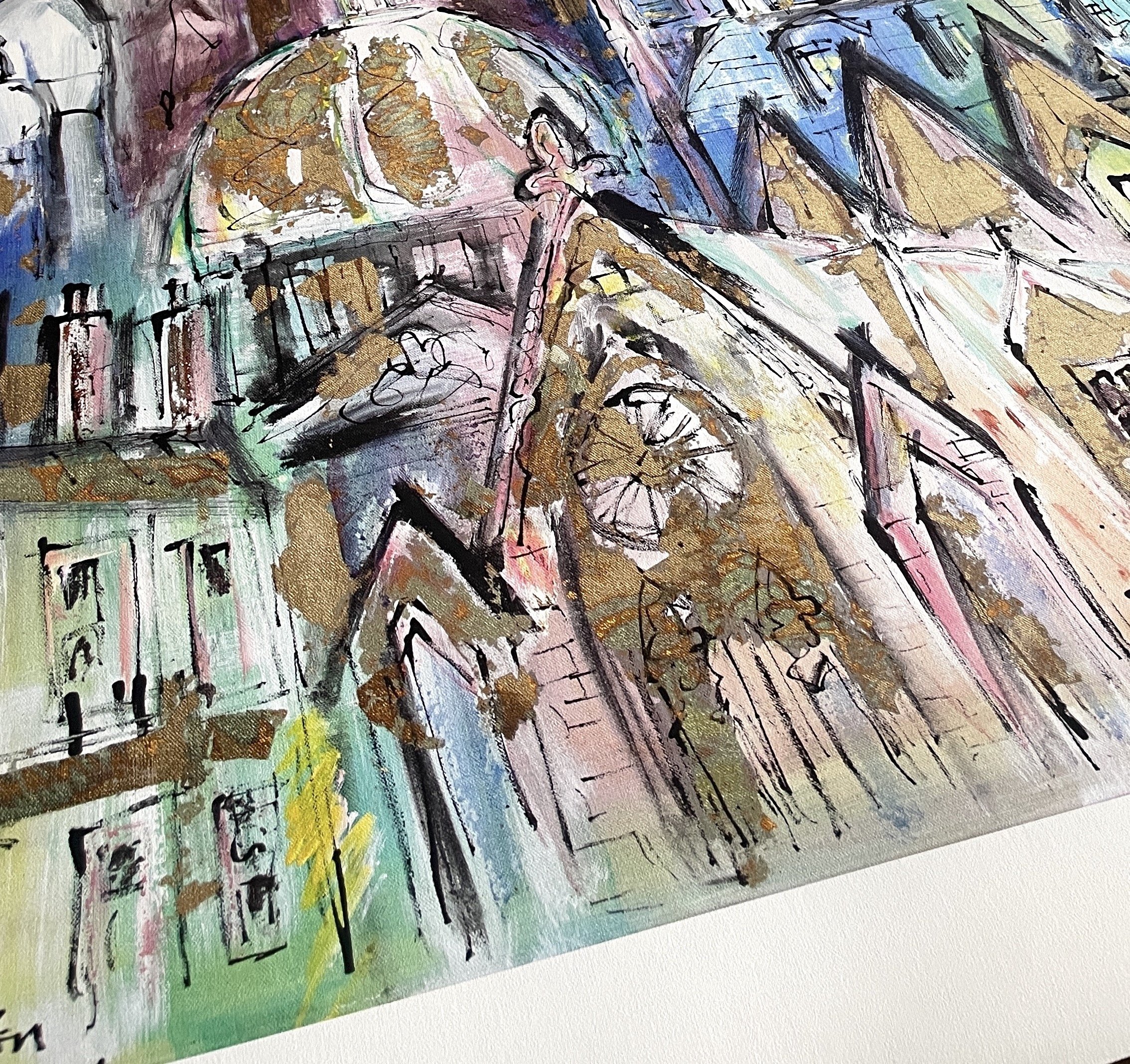 Abstract watercolor painting of a cityscape with buildings and a clock tower, outlined with black ink and accented with gold, pink, green, and blue hues.
