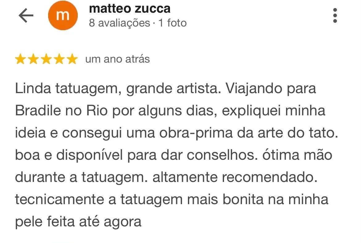 Avaliação de cliente com uma estrela e uma foto que parece ser uma tatuagem no braço.