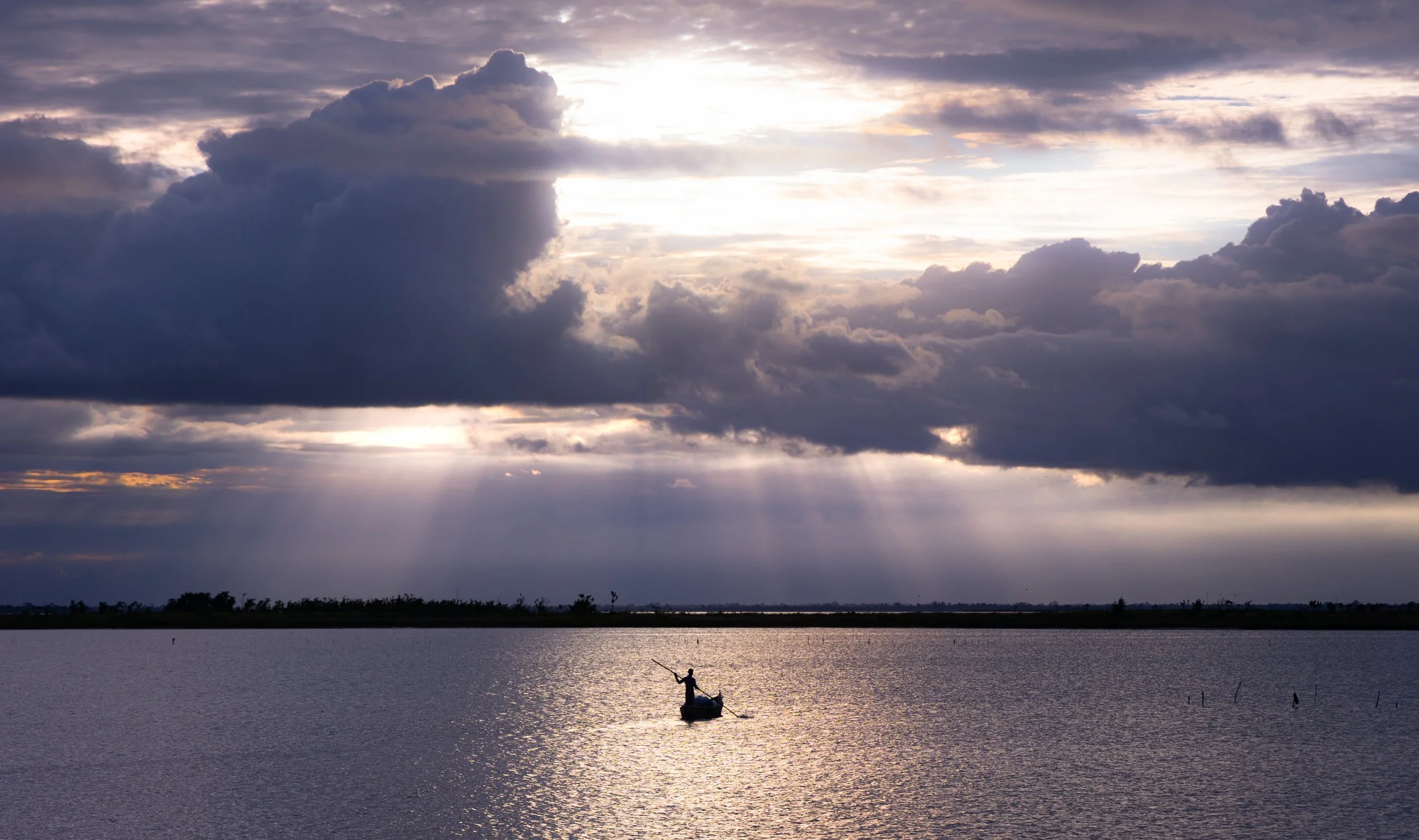 A boat at dusk in the Keta lagoon/