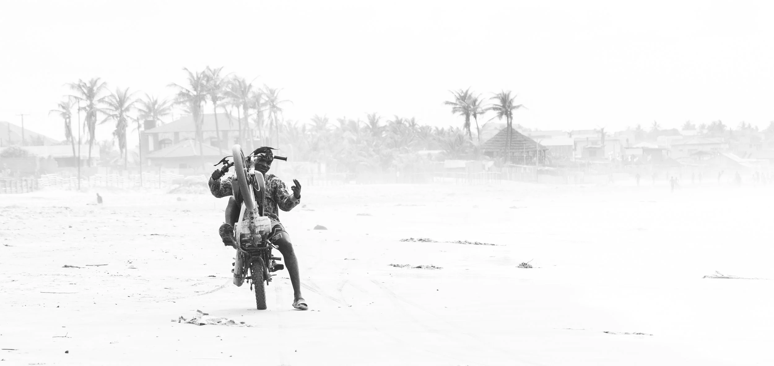 A motorcyclist ripping it down the Teshie beach.