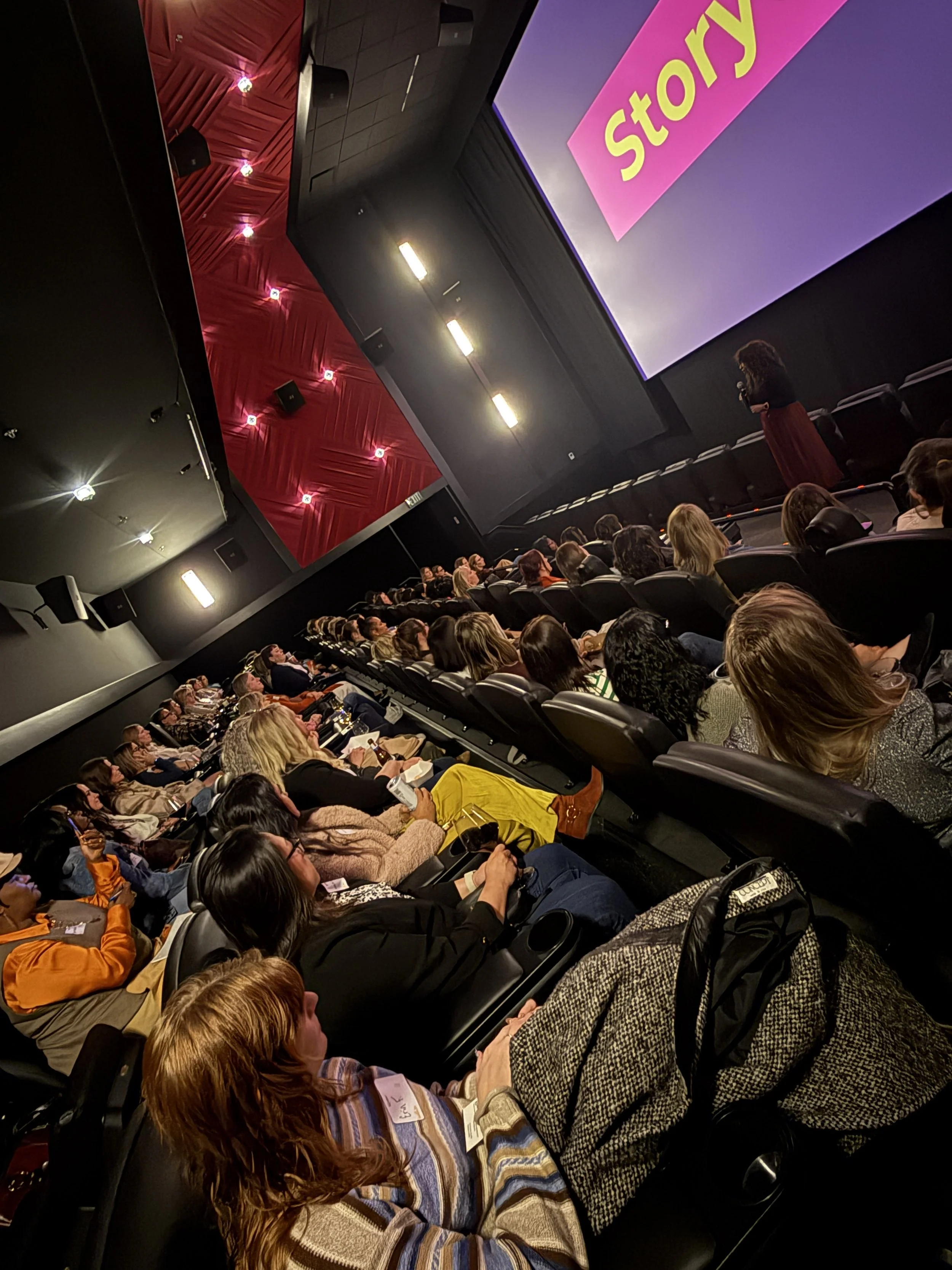 Photo of women gathered at a panel discussion during a Lead(H)er Huddle.