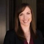 A woman with brown hair smiling at the camera