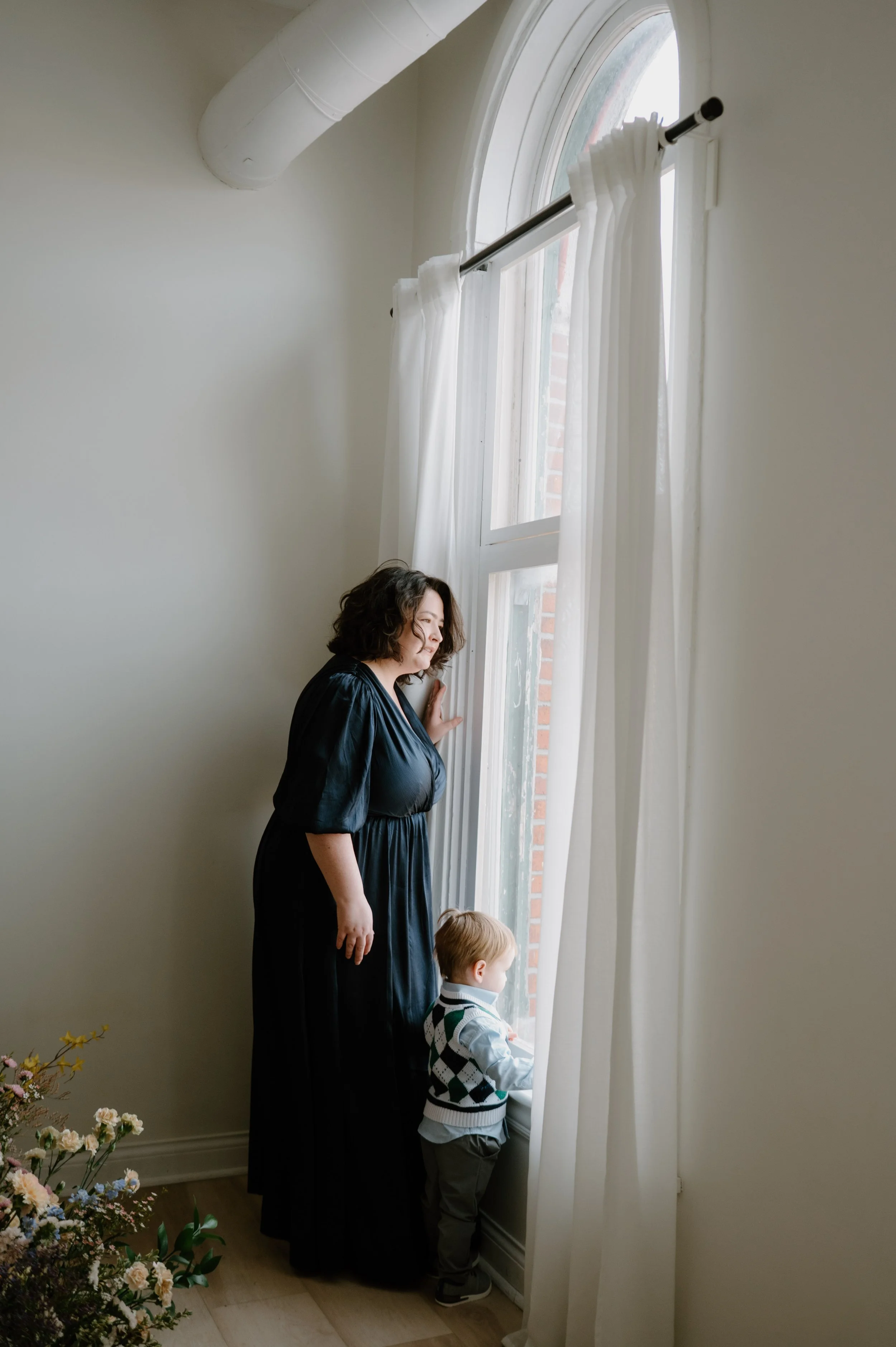 Rachael Bardnell and son looking out a window in Columbus Ohio.