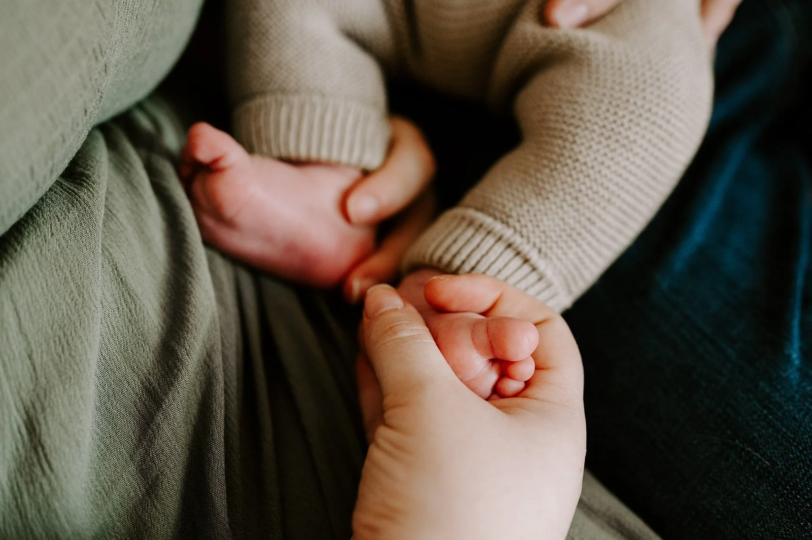Close-up of Rachael holding her newborn son's feet