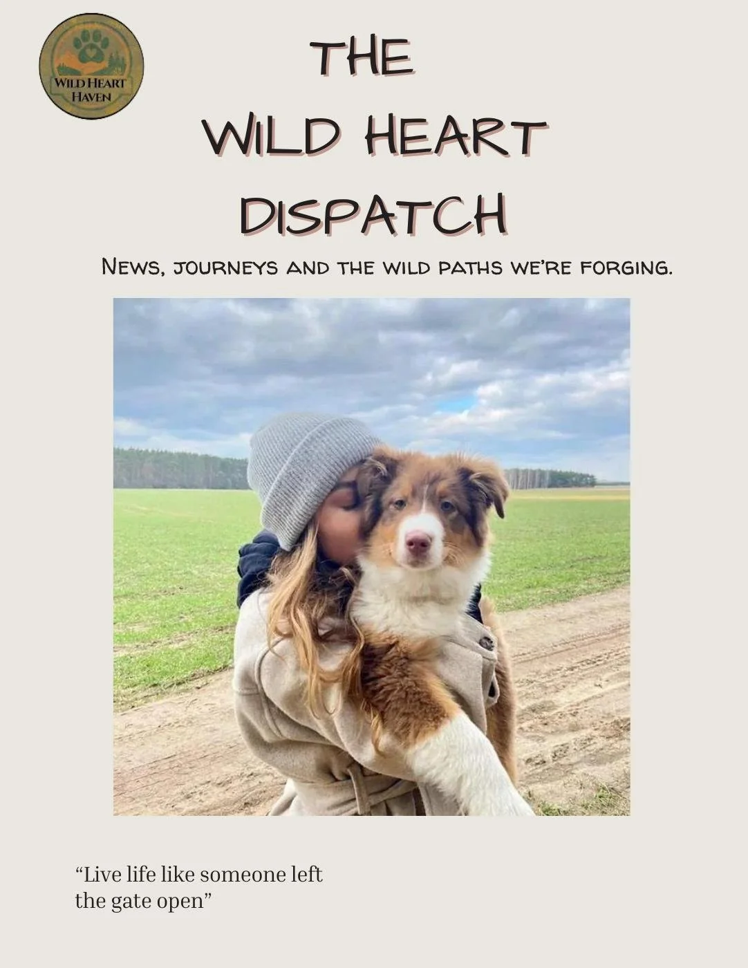 A girl in a gray beanie holding an Australian Shepherd puppy outdoors on a dirt trail, with green fields and a cloudy sky in the background.