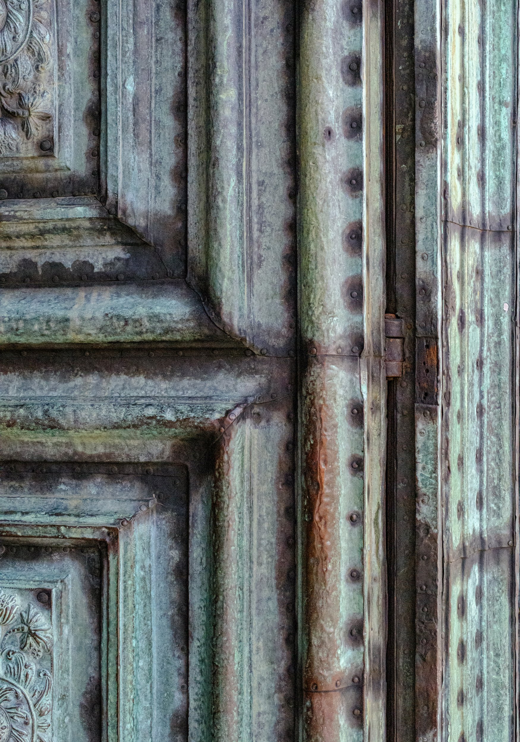 Minimalist composition: weathered copper clad door detail. 